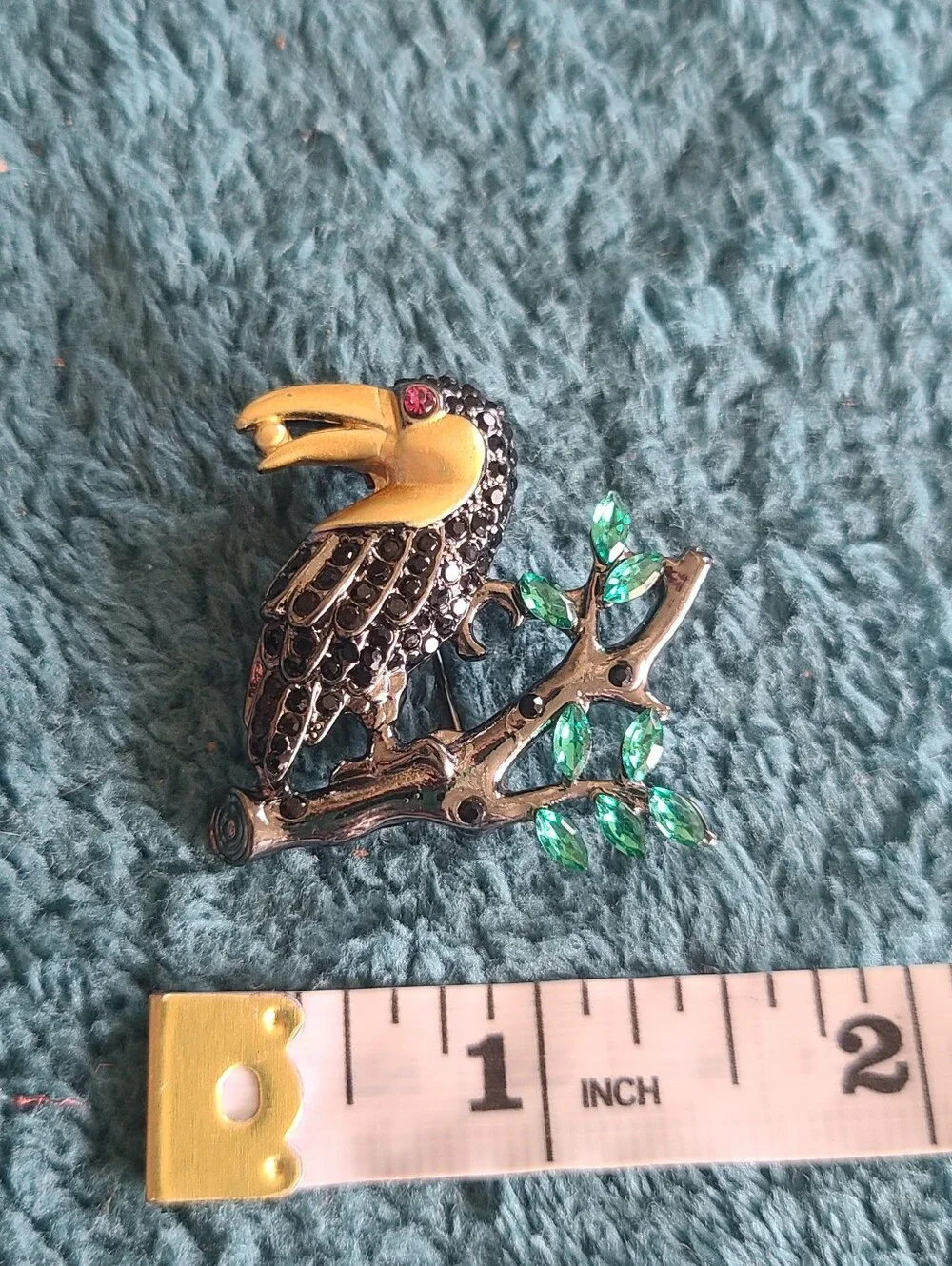 Vintage Gold-Accented Black Toucan Brooch with Green Leaves